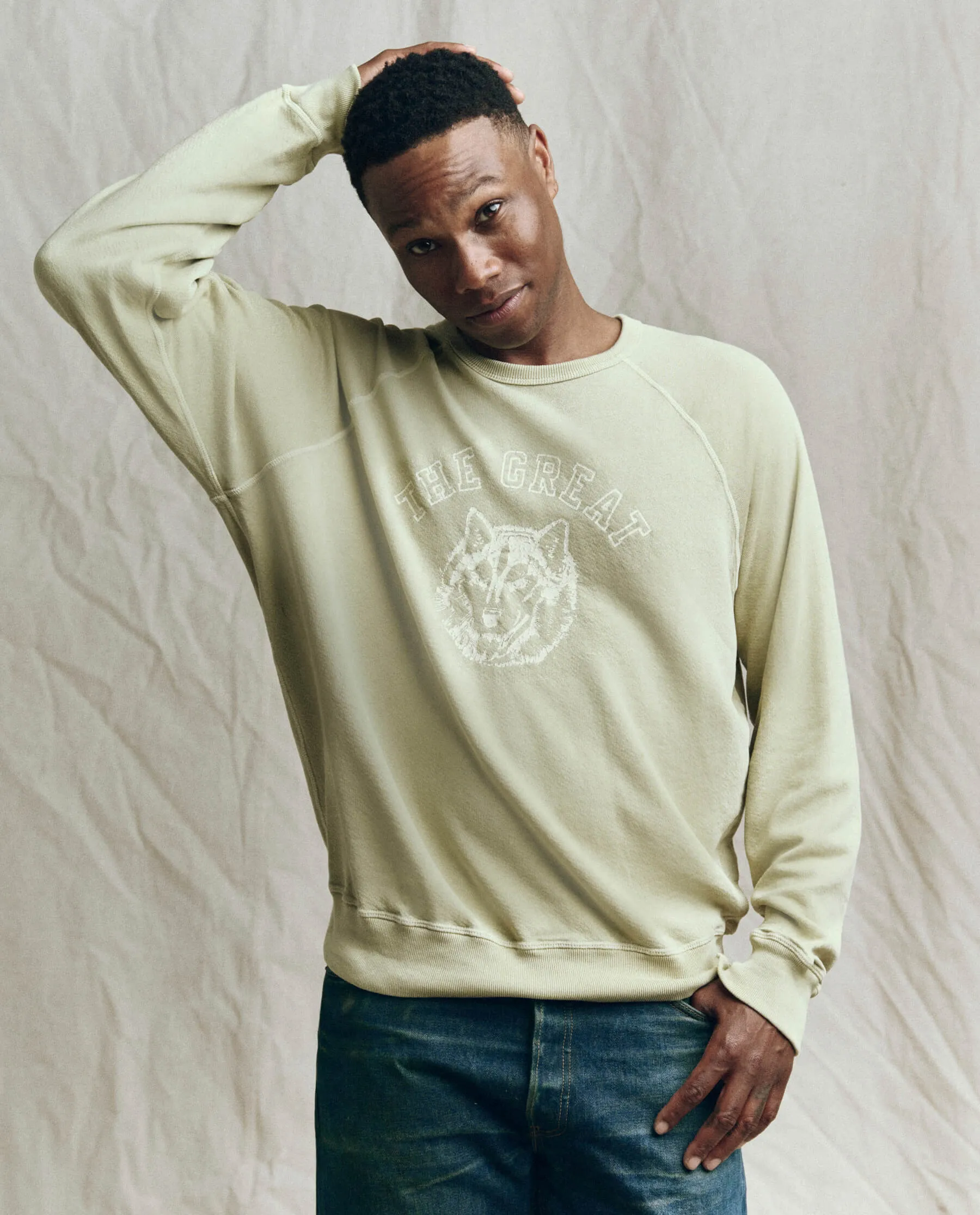 The Men's College Sweatshirt. -- Dusty Sweetgrass with Field Wolf Graphic